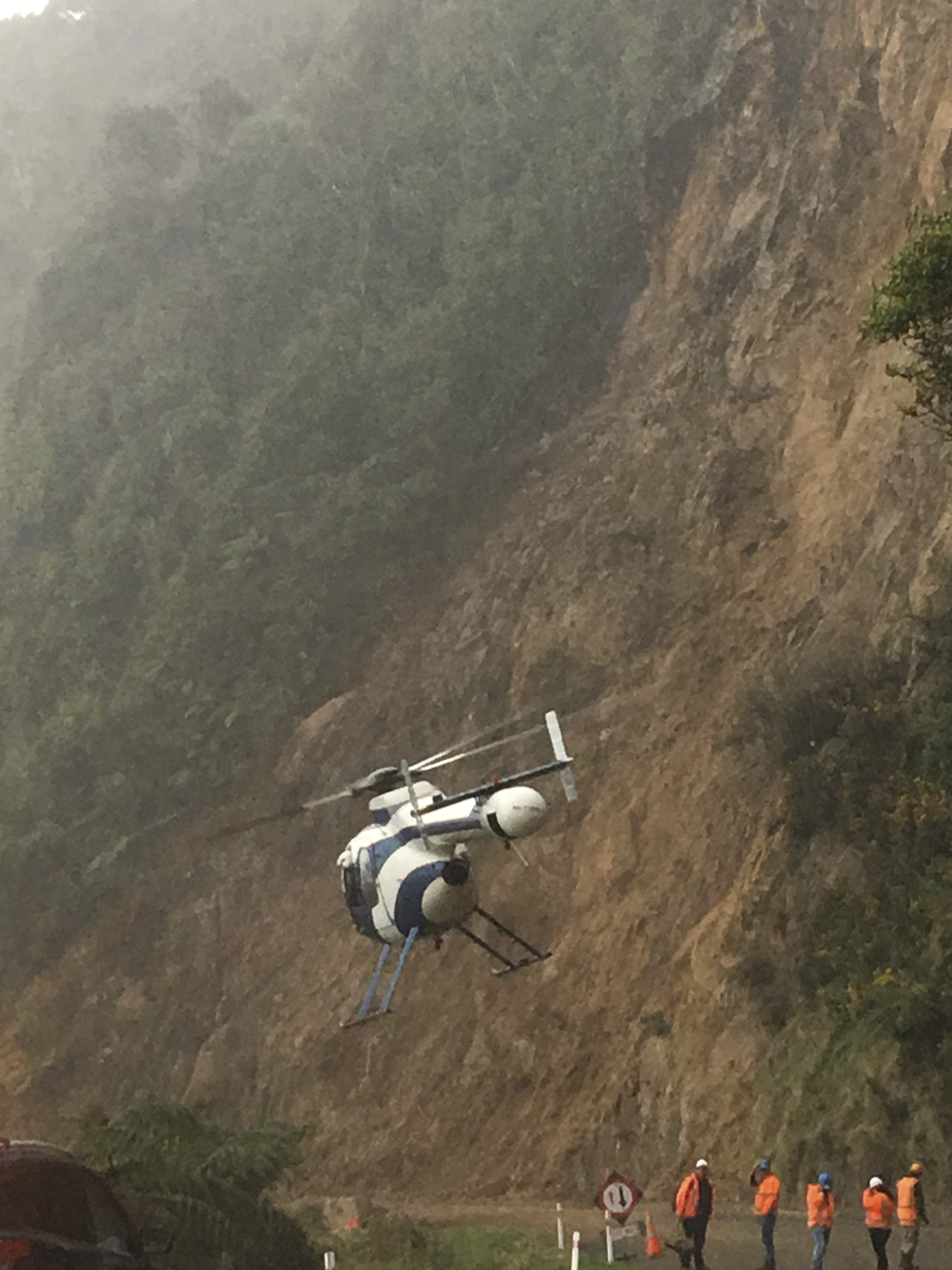 Helicopters sluiced the slip site into the early evening yesterday. Photo / Teresa Smith